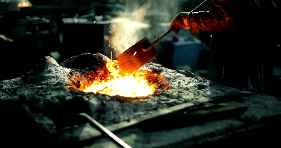 Foundry - Molten metal poured from lathe for casting iron product