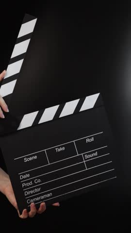 Hands with clapboard, commencing the shoot, Hollywood production in motion.