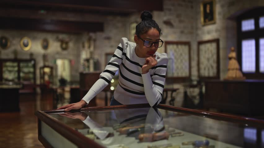 visitor in historical museum looking at art object