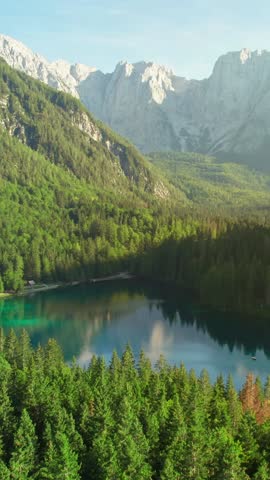 Aerial view of the Fusine Lake with Mount Mangart on the background. Fusine Lakes Natural Park, Tarvisio, Udine province, Friuli Venezia Giulia, Italy. Beautiful mountain lake in Italian Alps