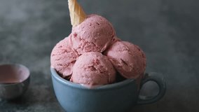 Creamy vegan ice cream in mug made with coconut yogurt, fresh strawberry. Summer seasonal cold sweet healthy dessert.