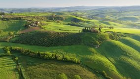 Classic Tuscany landscape with green hills and farmland country at sunrise. Aerial shot of green spring fields and hills in Tuscany, Italy - Powered by Shutterstock - Get 15% off with code: PIKWIZARD15