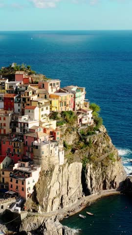 Manarola village drone vertical video, colorful houses, ligurian sea.