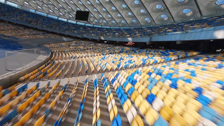 FPV flight, Stadium. cityscape time of day night. The view from the top to the illuminated stadium with games and fans. Stadium, Kiev, Ukraine, Soccer stadium field, soccer background, outdoor sport 