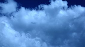 White clouds flying blue sky time lapse. Cumulus clouds fast flying sky timelapse. Abstract clouds flying, moving, running, rolling, morphing sky. Clouds flying, moving heavenly sky video footage.