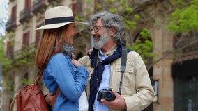 Lovely senior couple of tourist enjoying vacation together in city street. Older mature people in love having fun sightseeing european city during vacation or weekend getaway. Copy space for text - Powered by Shutterstock - Get 15% off with code: PIKWIZARD15