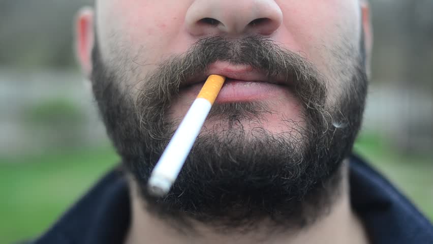 A man with beard is Smoking  Royalty-Free Stock Footage #35014981