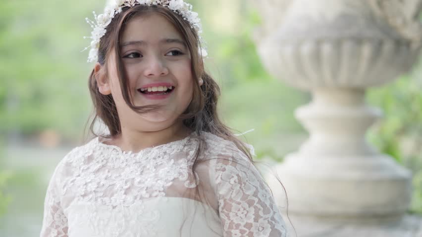 First Communion sweet girl spinning around in white dress in park 1.MOV
