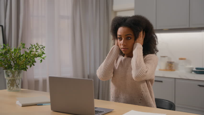 Annoyed angry woman African American businesswoman freelancer online working laptop at home kitchen stressed displeased mad female girl scream crazy with noise sound close ears disturb noisy at house Royalty-Free Stock Footage #3501575233