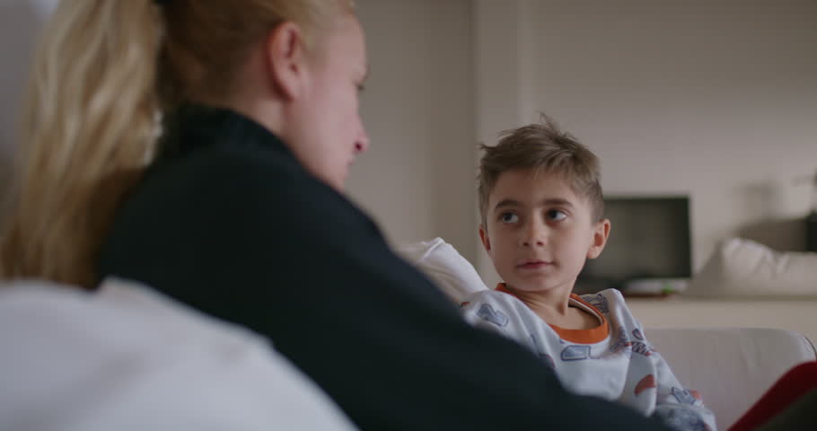 A mother is seen reprimanding her young son, who appears attentive and possibly remorseful, in the familiar environment of their home. Royalty-Free Stock Footage #3501587635