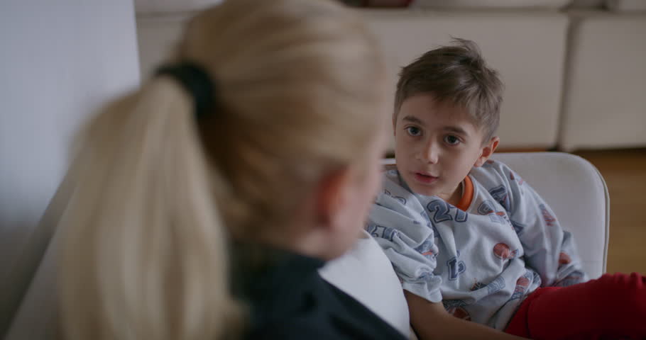 A mother is seen reprimanding her young son, who appears attentive and possibly remorseful, in the familiar environment of their home. Royalty-Free Stock Footage #3501595279