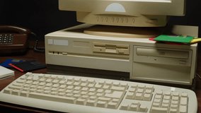 Using diskette FDD for old computer close-up. Hand inserting and ejecting Floppy Disk into vintage PC. Music recorder, playing retro computer games. 