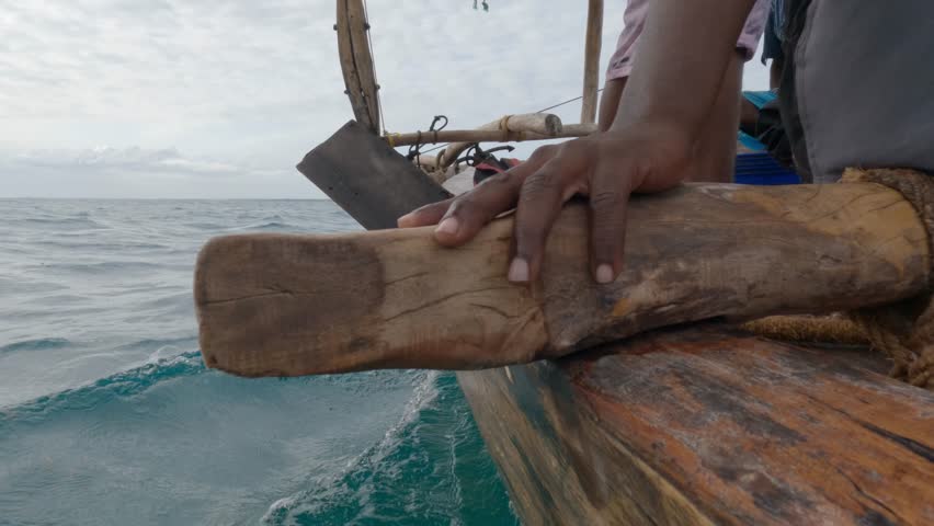 going through blue ocean in africa with wood boat