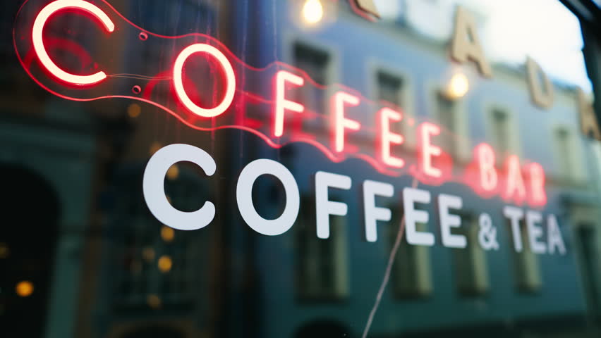 Neon sign on coffee bar window in electric blue font
