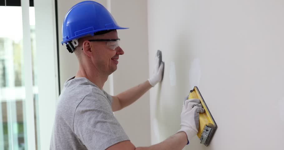 Grinding wall with sanding block master. Preparation before painting house renovation concept Royalty-Free Stock Footage #3501779469