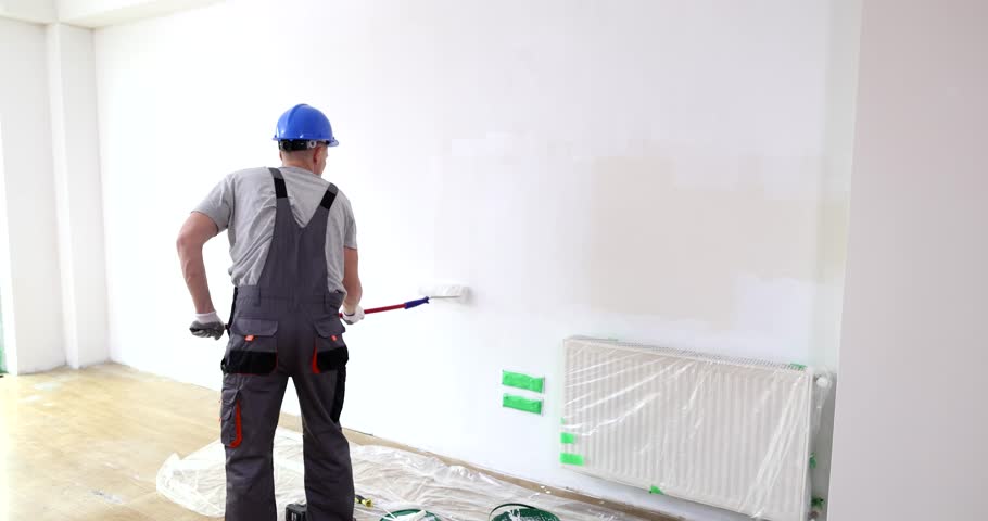 Painting walls with white paint using roller. Wall painting services for your home or office Royalty-Free Stock Footage #3501780869
