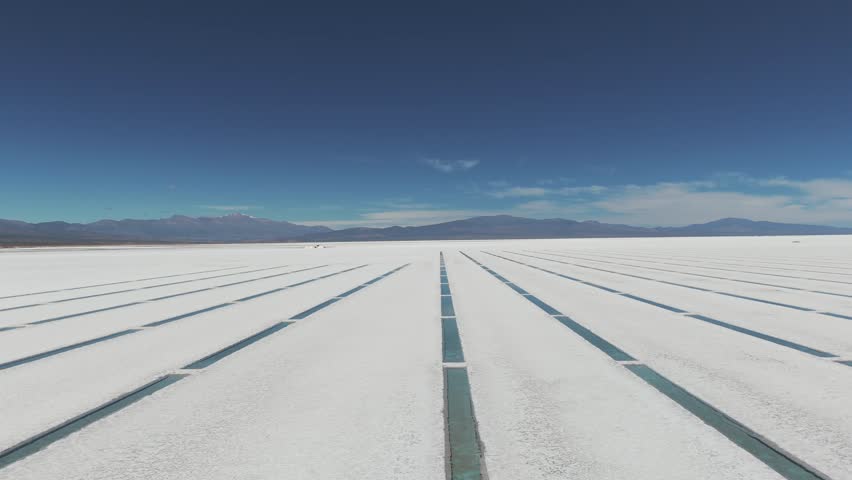 Aerial view over water stacks in natural salt flat of Salinas Grandes, Jujuy Province, Argentina. Slide right shot drone 4k