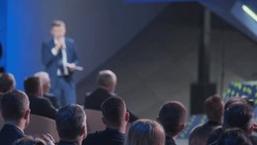 Focused shot of a business executive delivering a presentation to an attentive audience in a conference setting. The scene captures a professional atmosphere. - Powered by Shutterstock - Get 15% off with code: PIKWIZARD15