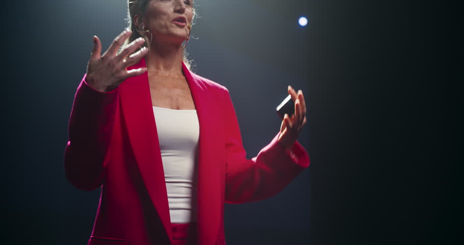 Visionary Company Manager Delivering a Positive Earnings Report at a Shareholders Event. Female Public Speaker Sharing Statistics, Future Goals and Leadership Insights to the Guests in the Room