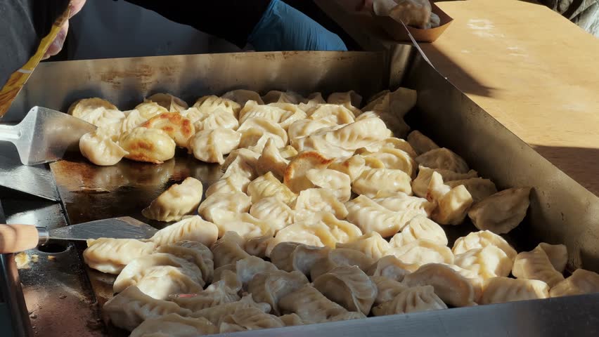 Baking gyoza, street food concept, Chinese food.