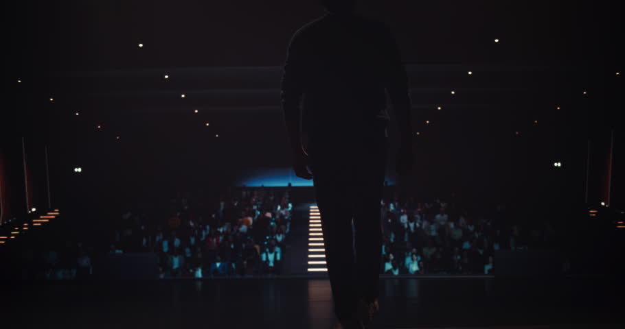 South Asian Speaker Welcoming the Audience as He Goes on Conference Stage. Businessman Giving a Powerful Speech and Showing Strong Gestures, While Motivating Audience to Buy His Product