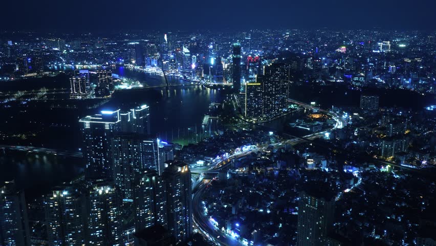 Nightlapse of Ho Chi Minh City, Saigon Vietnam at night with the view of the city center with bright lights and fast traffic timelapse