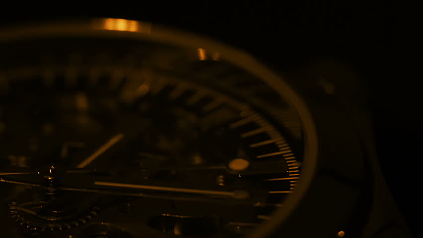 Watch close up. The light source moves around the watch. Tinted in gold