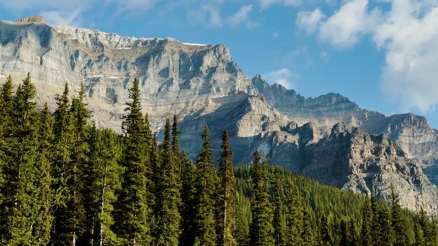 Moraine Lake is a Canadian glacial lake located in Banff National Park in Alberta. Sunrise at the lake. Moraine lake timelapse. Dense fir forests. Lakes in Canada. Extremely beautiful nature.
