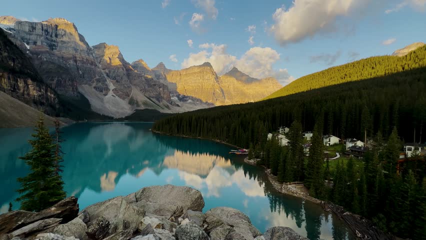 Moraine Lake is a Canadian glacial lake located in Banff National Park in Alberta. Sunrise at the lake. Moraine lake timelapse. Dense fir forests. Lakes in Canada. Extremely beautiful nature.
