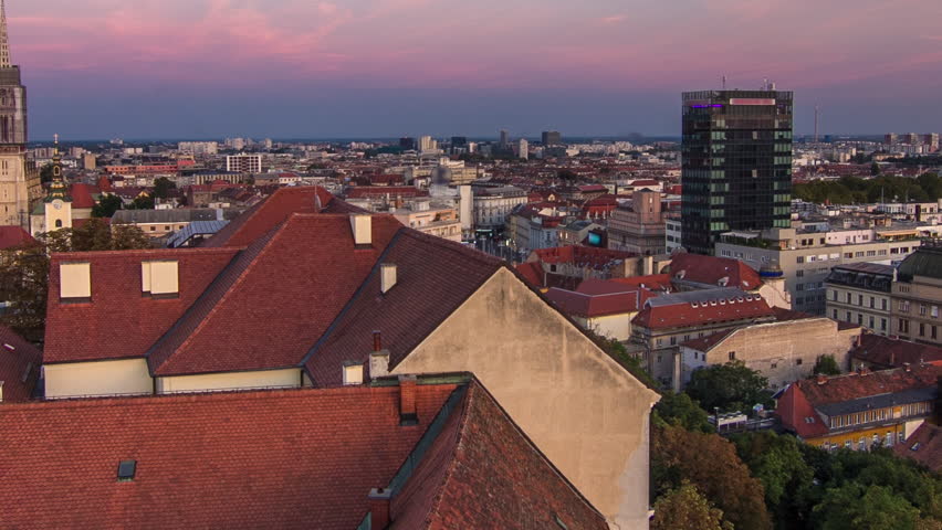 Kaptol and catholic cathedral day to night transition timelapse in the center of Zagreb, Croatia, panoramic top view of downtown from Kula Lotrscak tower after sunset