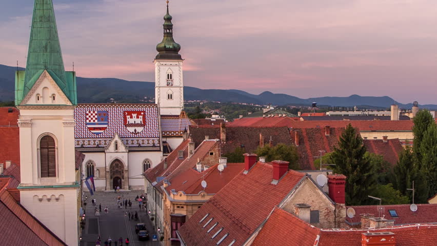Church of St. Mark day to night transition timelapse and parliament building Zagreb, Croatia. Top view from Kula Lotrscak tower viewpoint after sunset