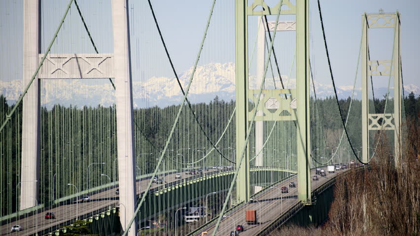 Daytime Commute on Tacoma Narrows Bridge with Olympic Mountains Background
