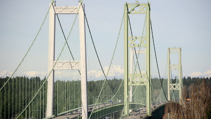 High Pillars of Tacoma Narrows Bridge on Sunny Day with Mountain Background