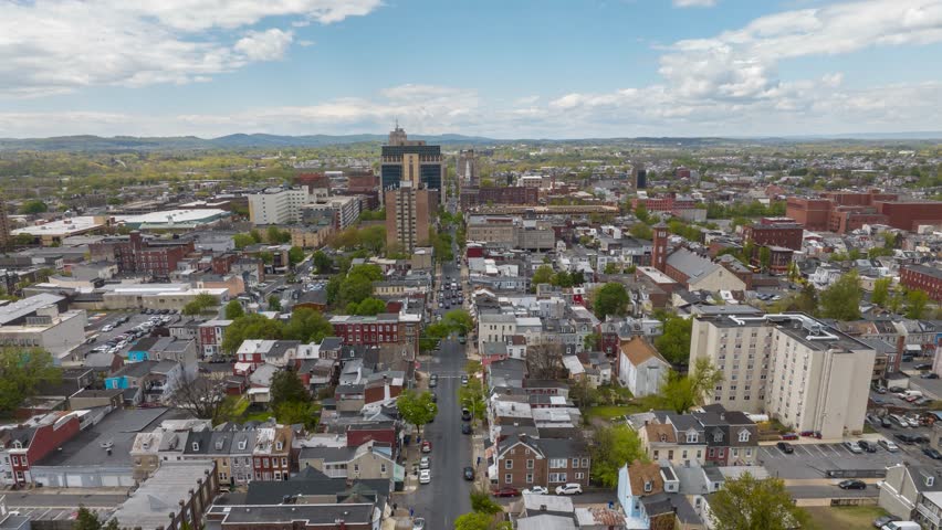 American city hyperlapse. Medium sized urban setting in USA. Traffic and row houses near downtown skyscrapers. Bright spring day.