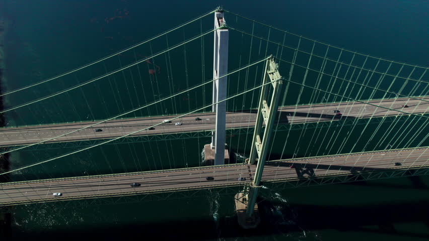 Birds Eye View Orbiting Tacoma Narrows Bridge Pillars with Cars in Motion