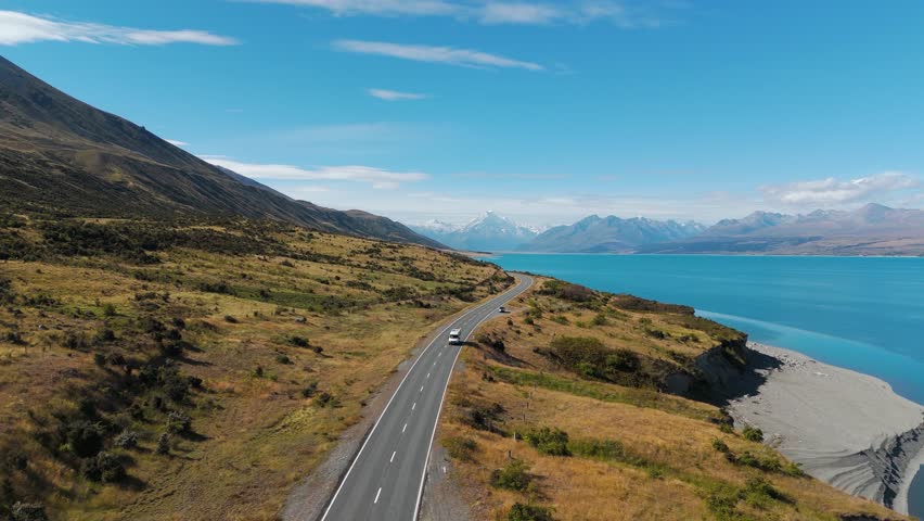 Camper van road trips across New Zealand driving along Lake Pulak, aerial