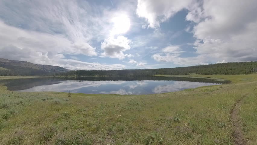 Clouds Reflect on Surface of Grebe Lake in Yellowstone National Park