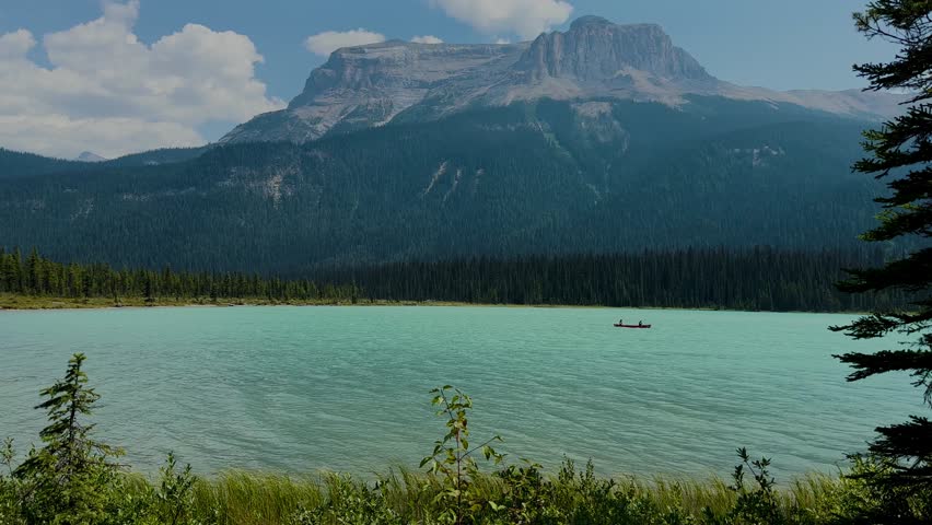 Emerald Lake is located in Yoho National Park in Canada. Famous for its emerald color and the splendid view of the Canadian Rockies that frame it. Canoe excursion with family. Trekking to the lake.

