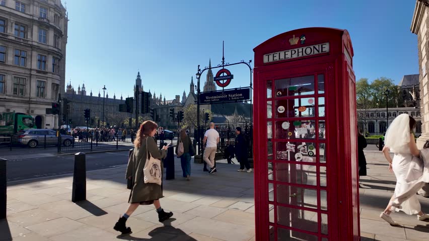 London , United Kingdom (UK) - 05 07 2024: Red telephone box near the entrance of Westminster Station on Parliament Street, London