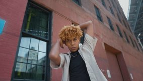 Flexible multiracial man dancing outdoors. Joyful dark skinned man in street style outfit dancing - Powered by Shutterstock - Get 15% off with code: PIKWIZARD15