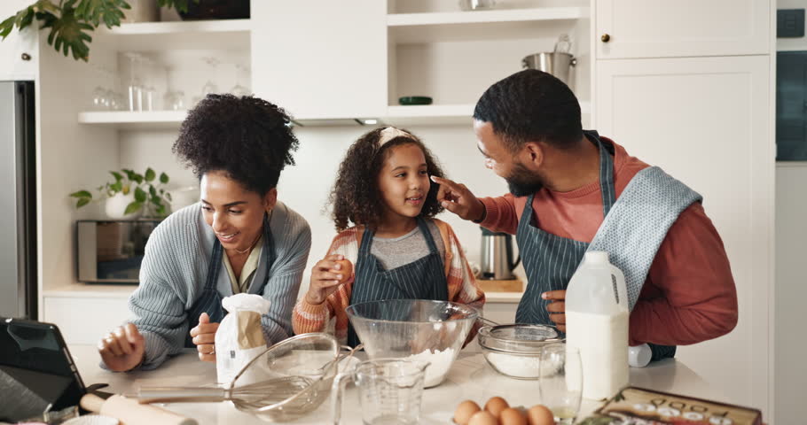 Family, kitchen and playing or baking with tablet, cooking ingredients and girl with parents. Nutrition, meal preparation and cutlery with healthy online recipe, helping and fun with dessert flour