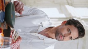 Two people enjoying dinner in restaurant terrace closeup. Luxurious rich couple celebrating anniversary in cafe patio vertically video. Romantic partners eating tasty food discussing dishes at table.  - Powered by Shutterstock - Get 15% off with code: PIKWIZARD15