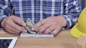 Engineer counting dollars concept of income from work - Powered by Shutterstock - Get 15% off with code: PIKWIZARD15