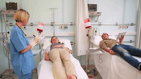 Animation of white shapes over diverse doctor and patients in hospital. Global medicine, healthcare, science and digital interface concept digitally generated video. - Powered by Shutterstock - Get 15% off with code: PIKWIZARD15