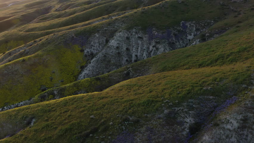 Aerial Drone Closeup Geological formations of Carrizo Plains mountain foothills california sunset landscape