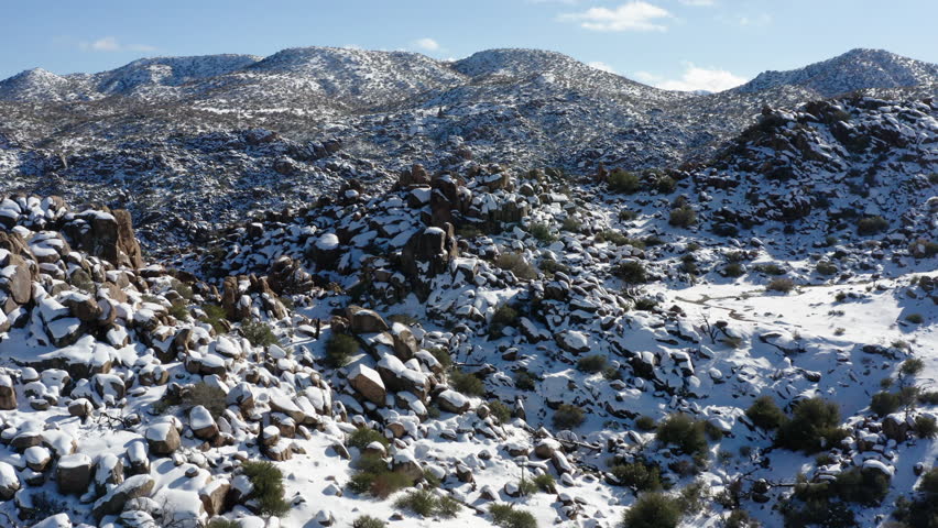 Winter scenery of Granite hills in Joshua tree national park covered in snow. Aerial shot