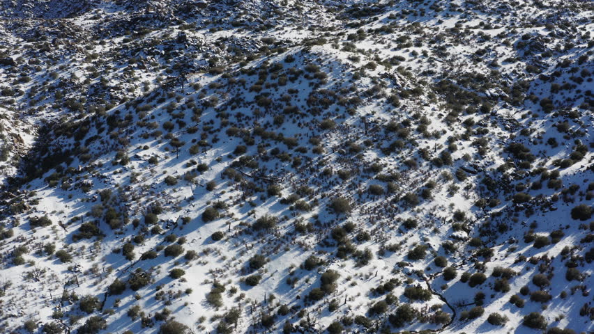 Granite hills, Joshua Tree National park, covered in snow. Winter aerial scene, California USA