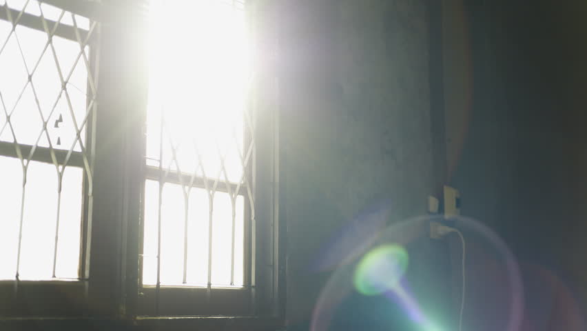 Shade and shadow on old window. Morning sunlight shining through the window. A ray of morning sun in an old window.