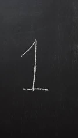 Hand writes the number 1 with white chalk on a black board. Vertical video
