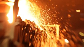Intense close-up of sparks flying from molten metal in a foundry, glowing warmly - Powered by Shutterstock - Get 15% off with code: PIKWIZARD15